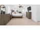 Spacious main bedroom with neutral walls, plush carpet, plantation shutters, ceiling fan, and TV at 2936 W Knights Ave # A, Tampa, FL 33611
