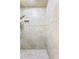 A tiled walk-in shower with decorative border and shower head at 2936 W Knights Ave # A, Tampa, FL 33611