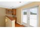 Cozy wet bar area with wood cabinets, sink, and double doors at 2936 W Knights Ave # A, Tampa, FL 33611