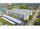 Aerial view of condominiums and a parking area with covered spaces surrounded by green trees at 2960 59Th S St # 614, Gulfport, FL 33707
