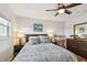 A bright bedroom with wood floors, ceiling fan, large window with view, and simple furniture set at 2960 59Th S St # 614, Gulfport, FL 33707