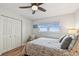 A bright bedroom with wood floors, ceiling fan, large window with view, and simple furniture set at 2960 59Th S St # 614, Gulfport, FL 33707