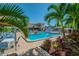 Beautifully landscaped community pool area with palm trees and plenty of seating, perfect for relaxation at 2960 59Th S St # 614, Gulfport, FL 33707