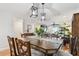 Dining area with hardwood floors, wooden table, stylish chairs, and modern light fixtures at 2960 59Th S St # 614, Gulfport, FL 33707