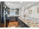 Modern kitchen featuring granite countertops, stainless steel appliances, and wood flooring at 2960 59Th S St # 614, Gulfport, FL 33707