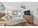 A bright main bedroom with wood floors, ceiling fan, closet, and beach art at 2960 59Th S St # 614, Gulfport, FL 33707