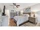 Comfortable main bedroom with wood floors, ceiling fan, closet, and wooden bedroom furniture set at 2960 59Th S St # 614, Gulfport, FL 33707