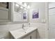 Neutral powder room with brushed nickel faucet and light fixture, white marble and paint at 2960 59Th S St # 614, Gulfport, FL 33707