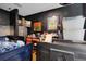 Cluttered bedroom featuring dark walls, a loft bed, and a variety of personal items and storage containers at 3008 Jackson N St, St Petersburg, FL 33704