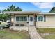 Charming single-story home with a covered front porch and well-maintained landscaping, creating a welcoming curb appeal at 3008 Jackson N St, St Petersburg, FL 33704