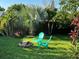 Landscaped backyard featuring two chairs, a fire pit, and palm trees at 3305 10Th N Ave, St Petersburg, FL 33713