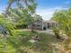 Backyard view showing the home and pergola, complimented with tropical trees and fire pit at 3305 10Th N Ave, St Petersburg, FL 33713