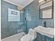 Modern bathroom with blue tiled walls, glass shower, and updated fixtures at 3305 10Th N Ave, St Petersburg, FL 33713