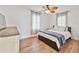 Cozy bedroom with wood floors, a comfortable bed with blue throw, and dresser at 3305 10Th N Ave, St Petersburg, FL 33713