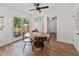 Bright dining area features a round table, modern light fixture, and sliding glass doors to backyard at 3305 10Th N Ave, St Petersburg, FL 33713