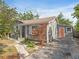 A charming home with gray siding, white trim, a coral door, and a paved driveway at 3305 10Th N Ave, St Petersburg, FL 33713