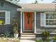 Close-up of the entry with coral-colored front door and decorative wreath at 3305 10Th N Ave, St Petersburg, FL 33713