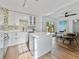 Modern kitchen featuring white cabinets, island, and dining area at 3305 10Th N Ave, St Petersburg, FL 33713