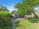 Backyard view of storage shed, wood pathway and lush trees at 3305 10Th N Ave, St Petersburg, FL 33713