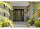 Close-up of a beautiful front door with decorative tiled landing, and elegant exterior lighting fixtures at 345 8Th Ne Ave, St Petersburg, FL 33701