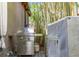 Stainless steel outdoor kitchen and grill near water feature and lush tropical landscaping at 345 8Th Ne Ave, St Petersburg, FL 33701