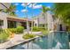 Gorgeous pool with a water feature, surrounded by lush landscaping and a covered patio at 345 8Th Ne Ave, St Petersburg, FL 33701