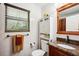 Full bathroom with granite countertop, updated fixtures, and cabinet with storage at 35031 Shale St, Webster, FL 33597