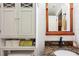 Bright bathroom featuring white tiled walls, a granite countertop, and built-in storage at 35031 Shale St, Webster, FL 33597