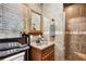 Nicely tiled bathroom featuring a walk-in shower, single vanity, and window at 35031 Shale St, Webster, FL 33597