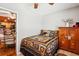 Bedroom with tiled floors, a bear themed bedspread, and view into a kitchen at 35031 Shale St, Webster, FL 33597