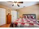 Comfortable bedroom with a patchwork quilt and ceiling fan, perfect for relaxation at 35031 Shale St, Webster, FL 33597