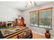 Cozy bedroom with natural light, wood accents, and a rustic-themed bedspread at 35031 Shale St, Webster, FL 33597