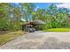 Metal carport with a truck and lawn equipment at 35031 Shale St, Webster, FL 33597