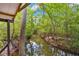 Scenic creek view from the porch surrounded by lush greenery, perfect for relaxation at 35031 Shale St, Webster, FL 33597