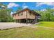 Elevated home with a screened in porch, stairs and gravel parking at 35031 Shale St, Webster, FL 33597
