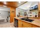 Cozy kitchen featuring wood cabinets, black appliances, tile countertops and flooring at 35031 Shale St, Webster, FL 33597