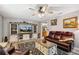 Inviting living room features a cozy atmosphere, ceiling fan, and entertainment center at 35031 Shale St, Webster, FL 33597