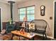 Quaint living area featuring a wood-burning stove, bench seating and a rustic wooden table at 35031 Shale St, Webster, FL 33597