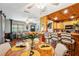 Open-concept living and dining area featuring a wood burning stove, dining table, and bar seating at 35031 Shale St, Webster, FL 33597