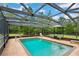 Private screened pool with seating area, umbrella and plenty of natural light at 35031 Shale St, Webster, FL 33597