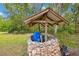 Well house covered by a timber frame at 35031 Shale St, Webster, FL 33597