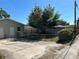 Backyard view with fenced yard, small patio and large shady tree at 3827 15Th N Ave, St Petersburg, FL 33713