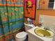 Colorful bathroom featuring unique shower curtain, a yellow sink, and vibrant decor at 3827 15Th N Ave, St Petersburg, FL 33713
