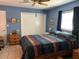 Bedroom with blue walls, ceiling fan and a window with dark curtains at 3827 15Th N Ave, St Petersburg, FL 33713