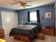 Bedroom with blue walls, ceiling fan and a window with dark curtains at 3827 15Th N Ave, St Petersburg, FL 33713