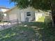 Rear exterior of home featuring fenced yard and detached garage with two chairs on the patio at 3827 15Th N Ave, St Petersburg, FL 33713