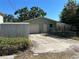 Rear exterior view of home with garage, shed, and chain link fence at 3827 15Th N Ave, St Petersburg, FL 33713