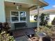 Cozy front porch with tiled floor, bench, lovely plants and wind chimes at 3827 15Th N Ave, St Petersburg, FL 33713