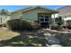 Front yard of single-story home with trimmed bushes and walkway to a covered porch at 3827 15Th N Ave, St Petersburg, FL 33713