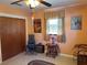 Living room with orange walls, one window, and a brown closet door at 3827 15Th N Ave, St Petersburg, FL 33713